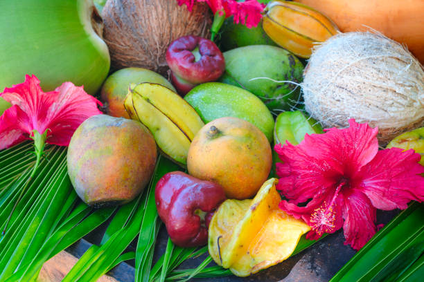 istock Many different tropical exotic fruits on a wooden table on the beach 2157272942
