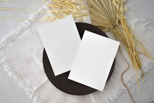 istock Two 5x7 Wedding Invitation Cards Mockup with dried palm leaf 2157273623