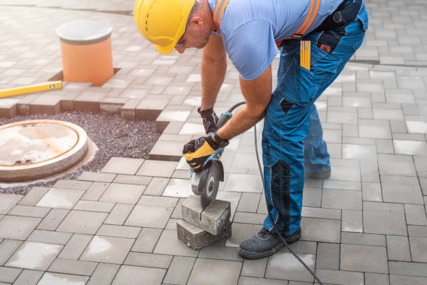 istock Laying interlocking paving. A worker sawing the paving stone with an angle grinder. 2157276214