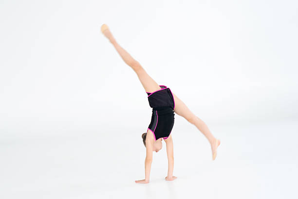 istock girl gymnast doing cartwheel 2157276702