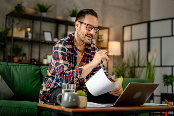 istock One men sitting and working from home, making a video call on a laptop, using technology concept 2157278085