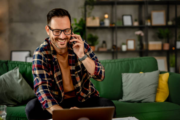istock One business men sitting and working from home, talking on a mobile phone, using technology concept 2157278233