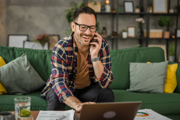 istock One business men sitting and working from home, talking on a mobile phone, using technology concept 2157278290