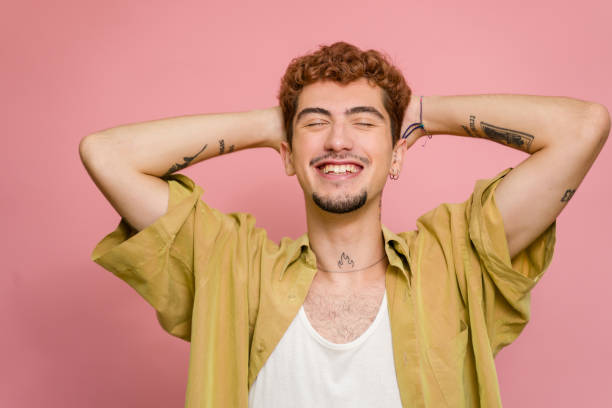 istock Young man with tattoos is relaxing with hands behind head 2157278323