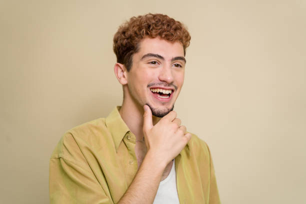 istock Young man with red hair is thinking and smiling 2157278582