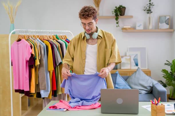 istock Young stylist preparing clothes for online sales using laptop 2157278901