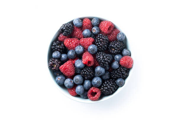 istock Fresh assortment berries in bowl isolated on white background 2157278944