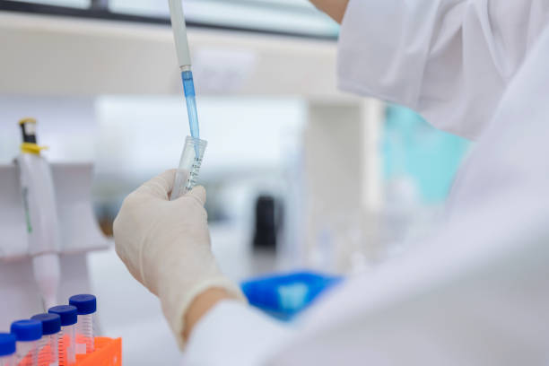 istock Researcher Using Micropipette to Release Solution into Test Tube in Laboratory 2157279173