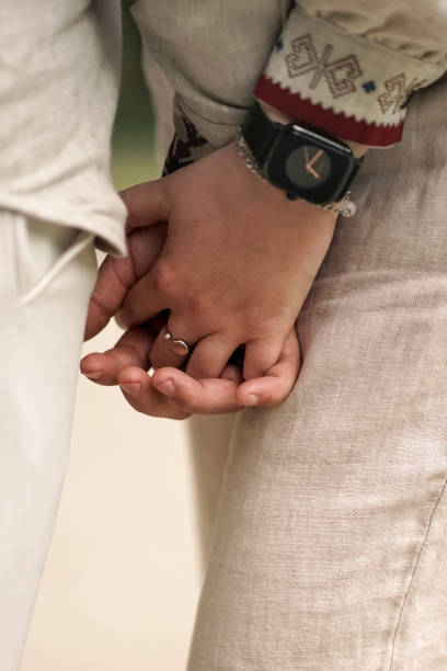 istock The groom presses the bride's hand to himself. 2157279450