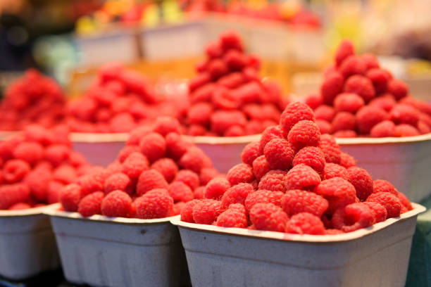 Baskets of raspberries in a market. High quality photo