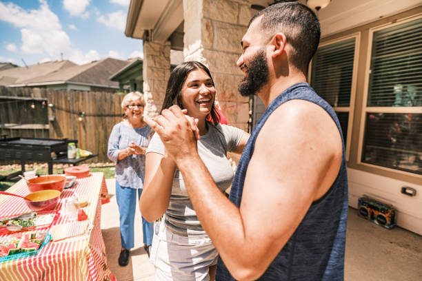Multi generation Latino family dancing at the backyard party