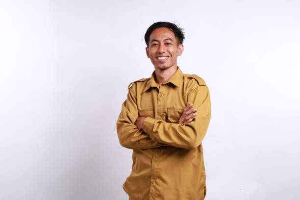 istock Indonesian government employees standing while smiling and looking at the camera. Isolated on white 2157281415