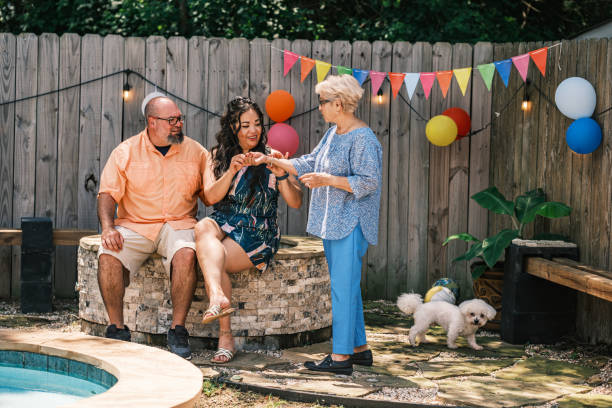 istock Latino family members taking a break at the backyard party 2157283405