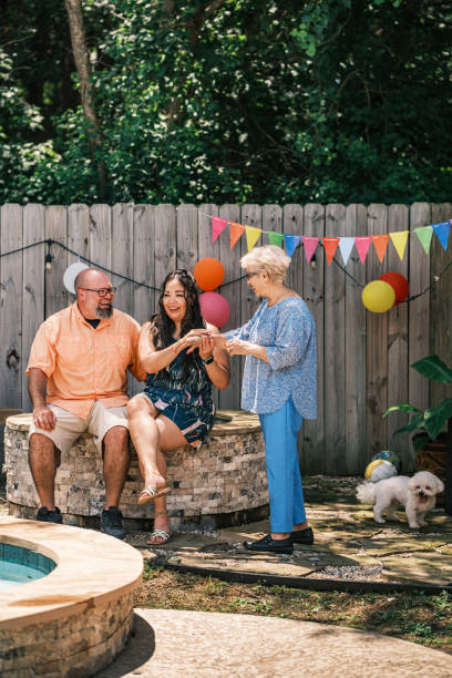 istock Latino family members taking a break at the backyard party 2157283413