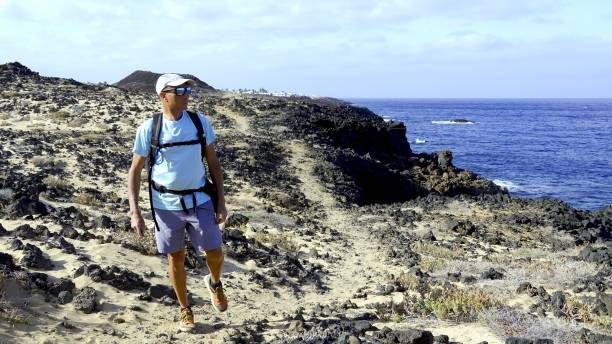 istock Young adult man walks the oceanfront path 2157286768