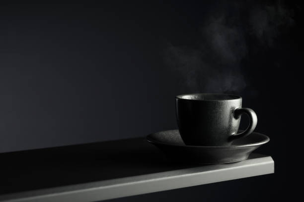 istock Black cup of coffee on a black background. 2157287798