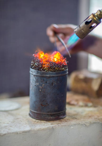 Selective focus. High temperature burner, metal melting, jewelry making. Close up. Vertical view.