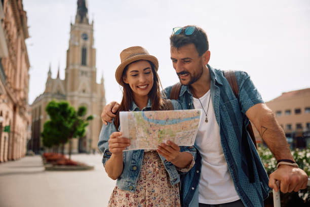 istock Happy woman and her boyfriends looking at map while exploring the city. 2157291047