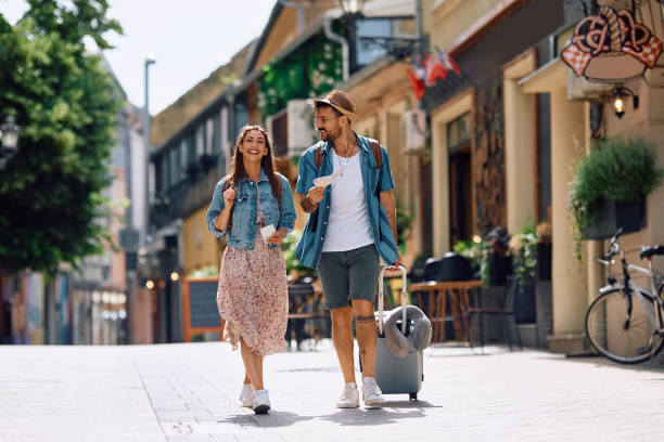 istock Young happy couple walking through the town while enjoying in summer trip. 2157291856