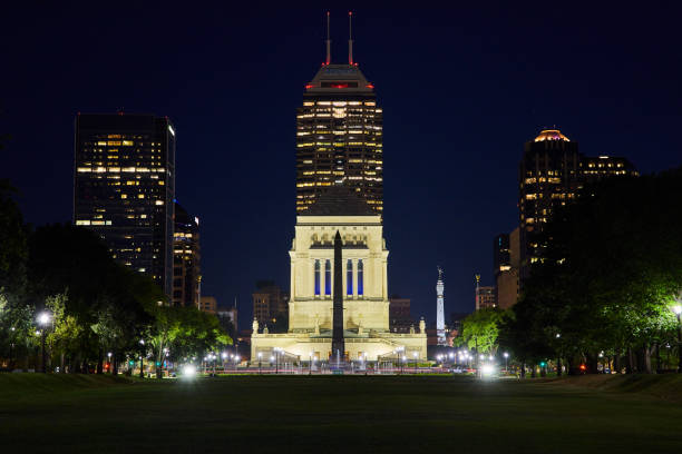 istock Serene Park at Blue Hour with Illuminated Monument and Modern Skyscrapers 2157293401