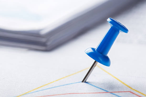 Marking financial chart by pins.Share listing and checking financial chart. Concept of banking, financial report and financial audit.