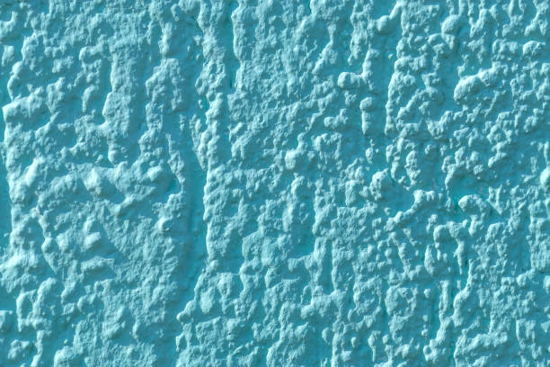 Turquoise background. Wall textures in pastel turquoise. Close-up.