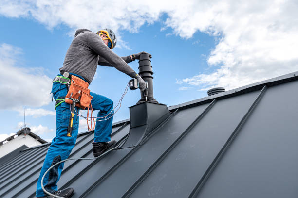 istock Work at heights. A tinman with tool belt and climbing harness on the roof is working with a cordless drill on the chimney sheeting. 2157297978