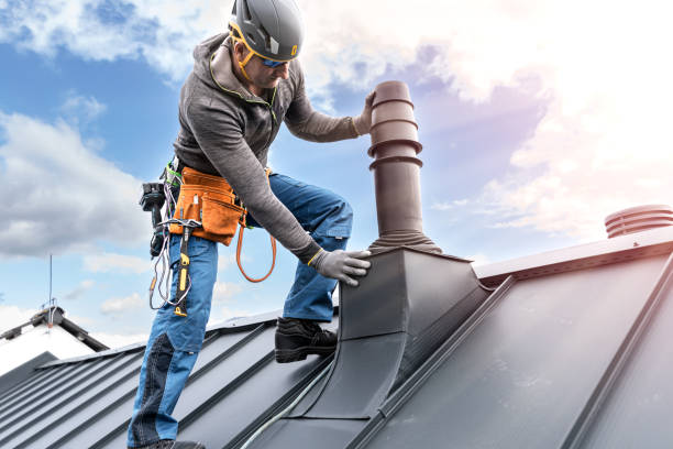 istock Work at heights. A tinman with tool belt and climbing harness on the roof is working with a cordless drill on the chimney sheeting. 2157298147