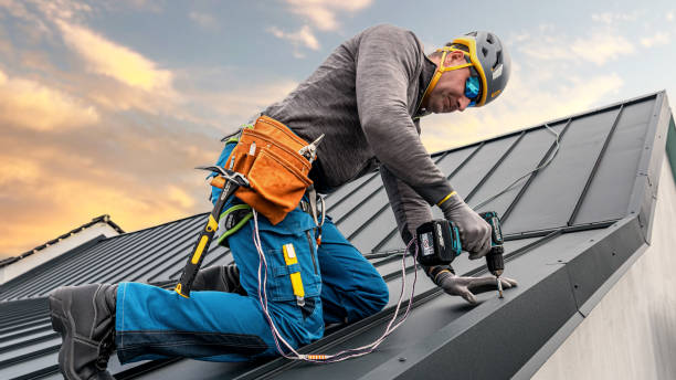 istock Work at heights. A tinman with a climbing harness and the tool belt is working with a cordless drill on the roof during sunset. 2157298230