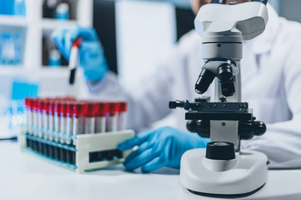 istock Scientists test the chemical reactions of the colored liquid solution and test biological fluids in test tubes. 2157300524