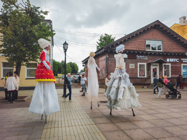 Gatchina, Russia-June, 08, 2024: In small town of Gatchina carnival of animation teams for the anniversary of the poet Alexander Pushkin. People in bright, beautiful costumes go on stilts.