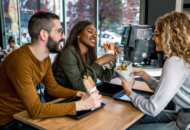 istock Friends enjoying lunch at a fast-restaurant 2157304175