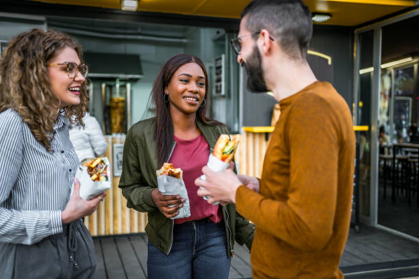 istock Young friends having street fast food 2157304342