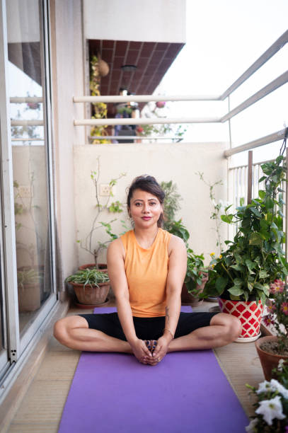 istock Woman Practicing Yoga on Balcony 2157304434