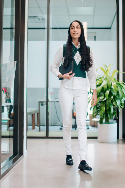istock Business Woman Walks Through Modern Office Setting 2157306736