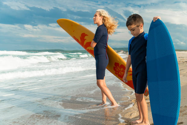 istock Mother and son ready to surf together 2157307128