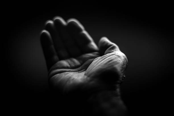 istock Black and white. Wrinkled right hand on a black background 2157308190
