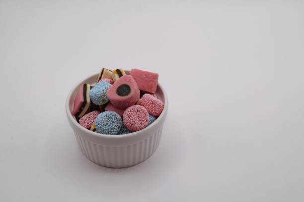 close up of mixed candy on a white background