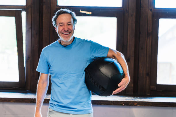 istock A man is holding a black ball in his hand and smiling 2157311401