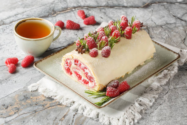 istock Berry sponge roll cake with jam, fresh raspberries, cream cheese covered with white chocolate close-up in a plate. Horizontal 2157318706