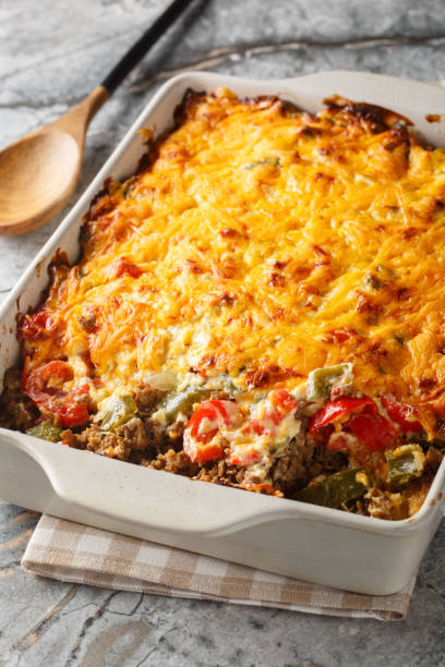 istock Delicious John Wayne casserole with beef, biscuits, cheese and vegetables close-up in a baking dish. Vertical 2157318891