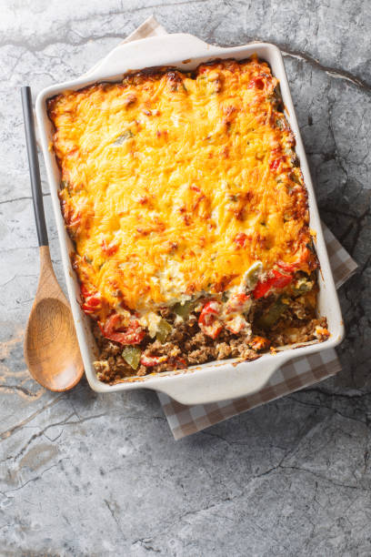 istock Delicious John Wayne casserole with beef, biscuits, cheese and vegetables close-up in a baking dish. Vertical top view 2157318934