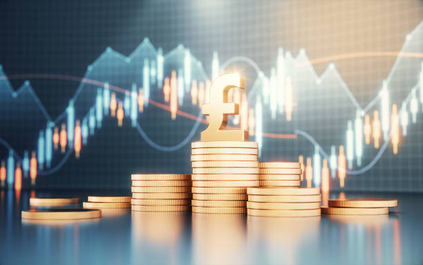 istock Pound Symbol on Metal Coins on Finance Background 2157319454