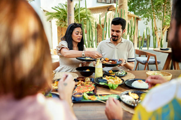 istock Woman serving food to man at dining table 2157320894