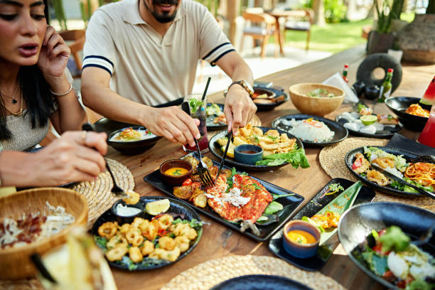 istock Man and woman eating appetizer at resort 2157320932