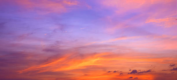 istock Dusk sky background after sundown with colorful orange sunlight clouds on blue evening sky, panoramic view 2157321359