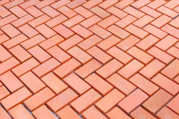 Zigzag brick floor pattern of pedestrian pavement in under construction, high angle view with copy space