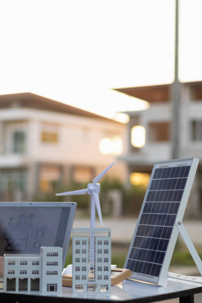 istock Engineers are reviewing plans from architects to prepare to install solar panels and wind turbines on the building to efficiently produce electricity using the concept of green energy from solar cells 2157323029