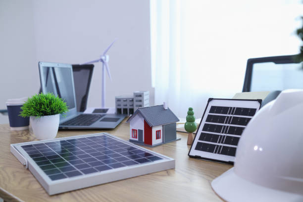 istock Engineers are reviewing plans from architects to prepare to install solar panels and wind turbines on the building to efficiently produce electricity using the concept of green energy from solar cells 2157323248