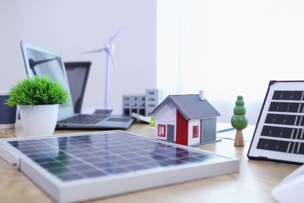 istock Engineers are reviewing plans from architects to prepare to install solar panels and wind turbines on the building to efficiently produce electricity using the concept of green energy from solar cells 2157323388